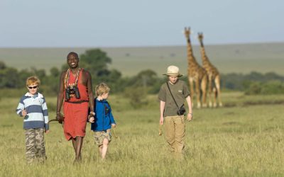 Local Maasai guide teaching kids during cultural family safari experience